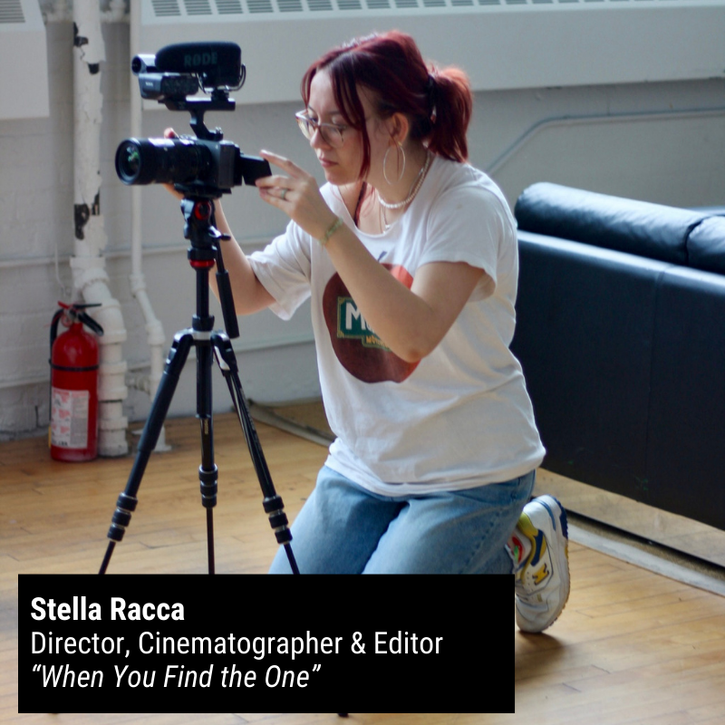 Stella Racca kneels behind a camera on a tripod