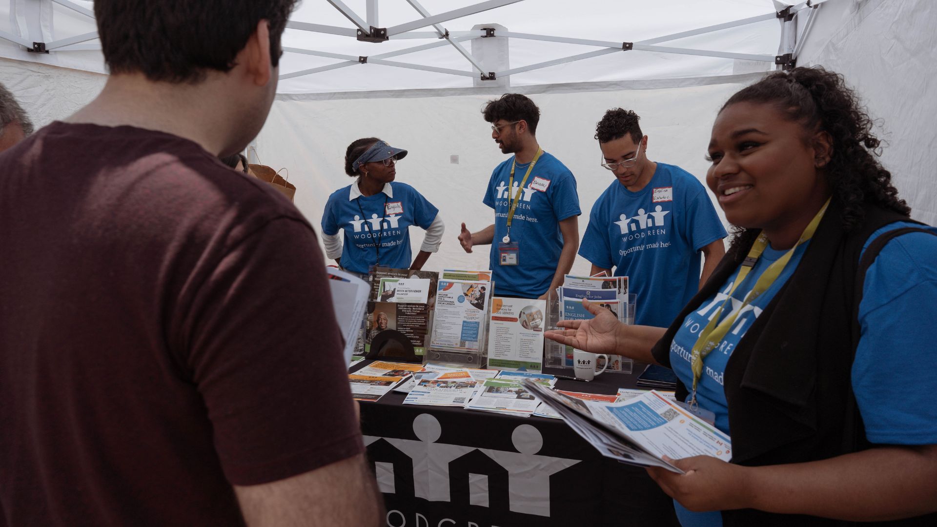 WoodGreen team members welcome community member at our Toronto Newcomer Day booth. 