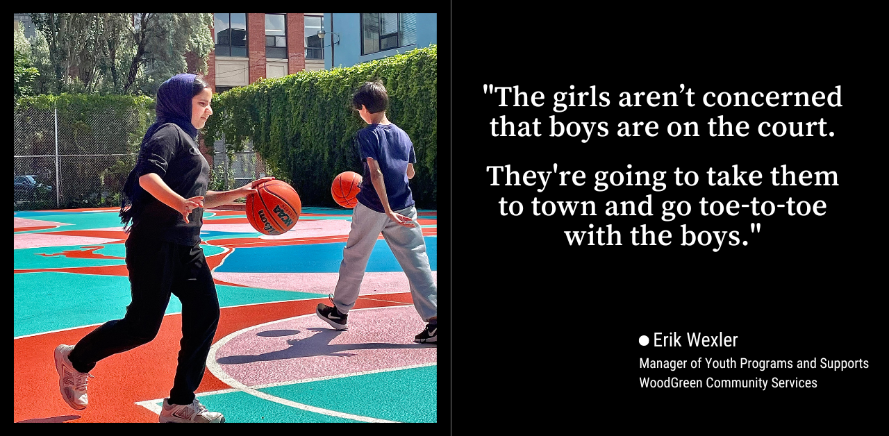 A teenage girl in a headscarf and black clothing bounces a basketball on a colourful outdoor court. 